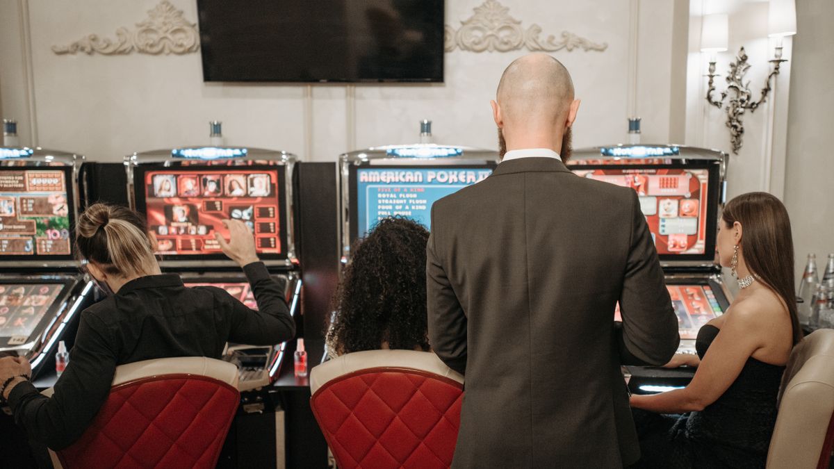 Sekelompok pemain mencoba mesin slot di kasino