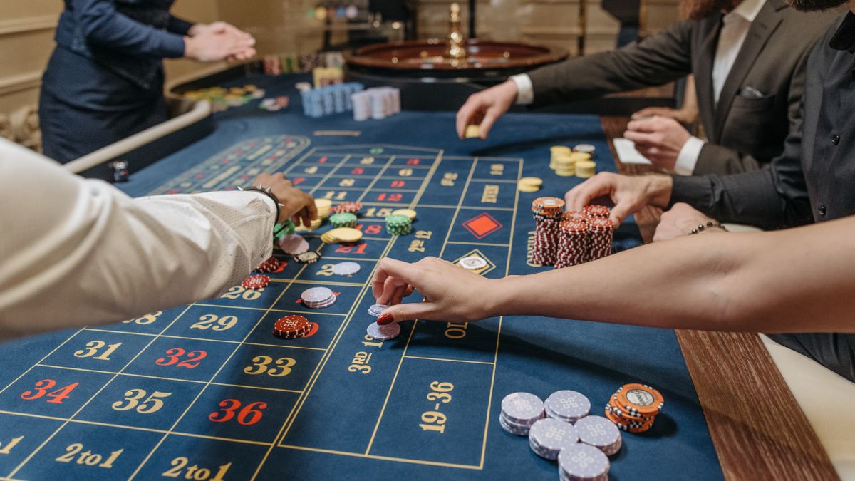 Chip taruhan tersusun di atas meja kasino